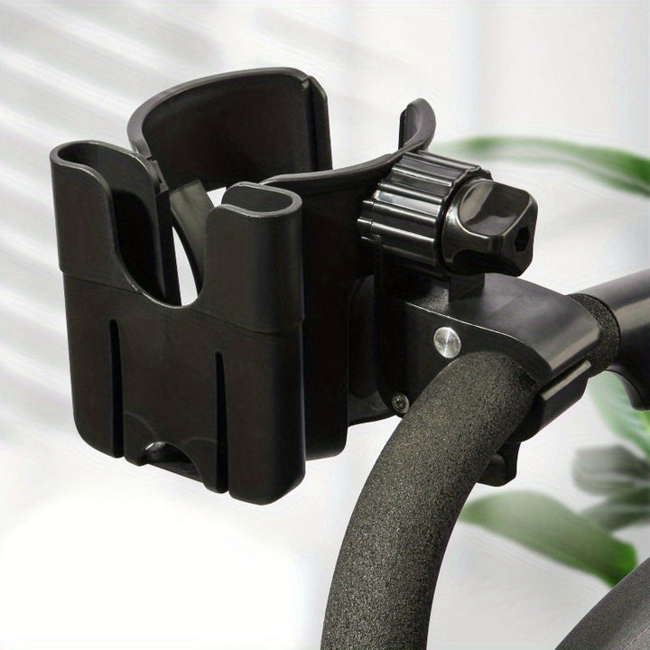 Black cup and phone holder mounted on a padded stroller handle.