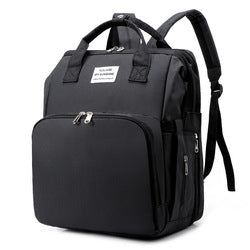 Black diaper backpack with front zip pocket, top handles and shoulder straps