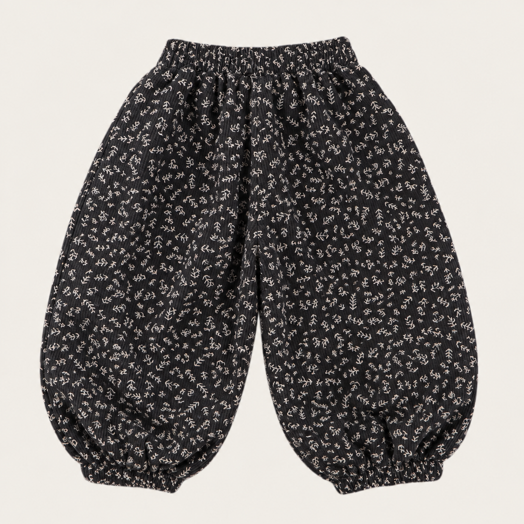Black pants with a small floral pattern, elastic waistband, and gathered cuffs