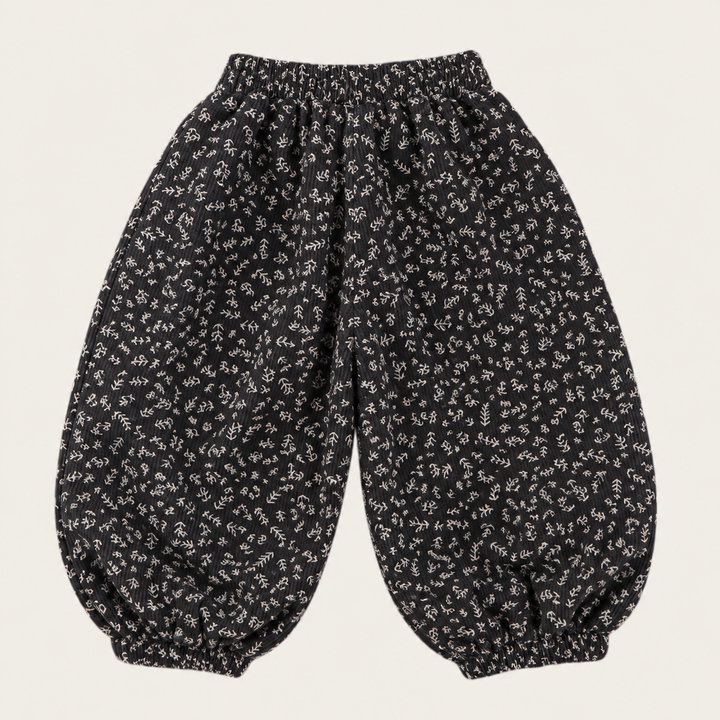Black pants with a small floral pattern, elastic waistband, and gathered cuffs