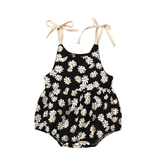 Black baby romper with white floral print and tie-up shoulder straps