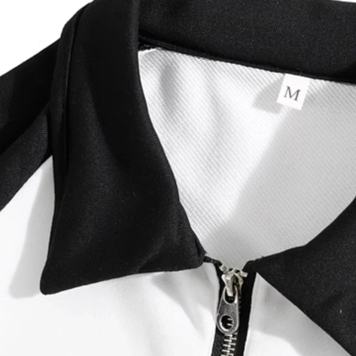 Close-up of the black collar and short zipper on the white sweater.