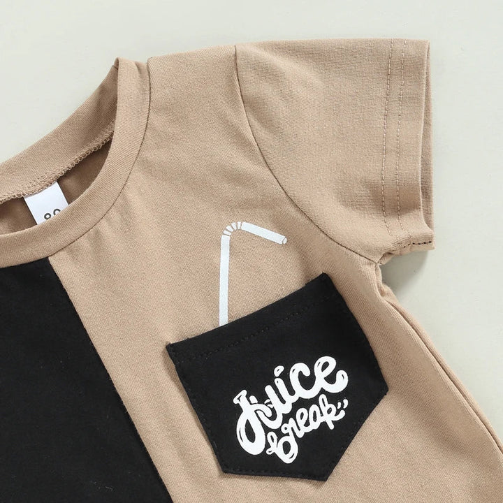 Close-up of the black graphic chest pocket, beige sleeve and round neckline