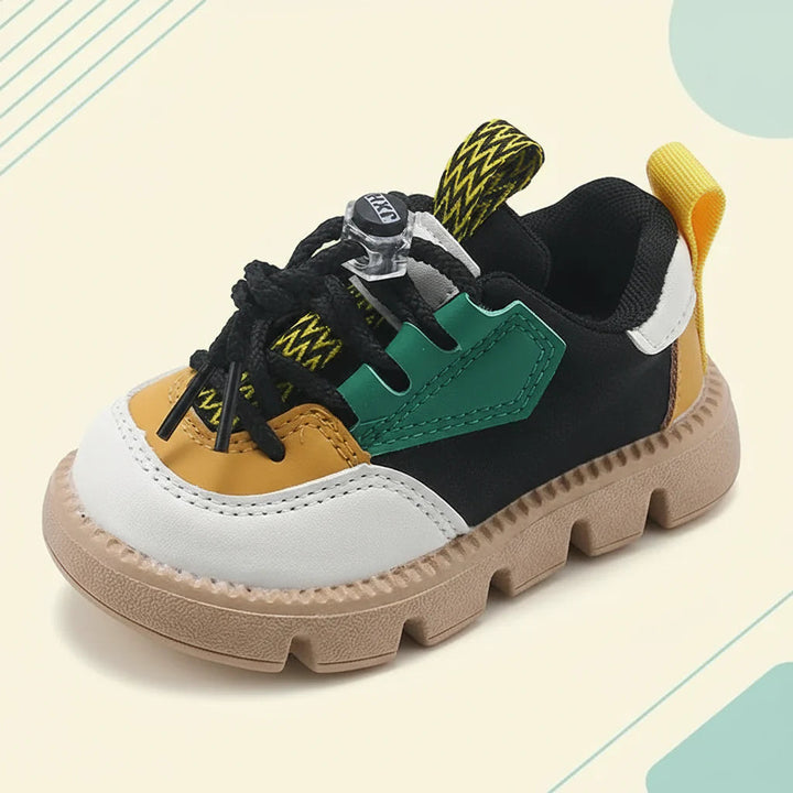 Black and green sneaker with adjustable laces, a yellow heel tab and a thick tan sole