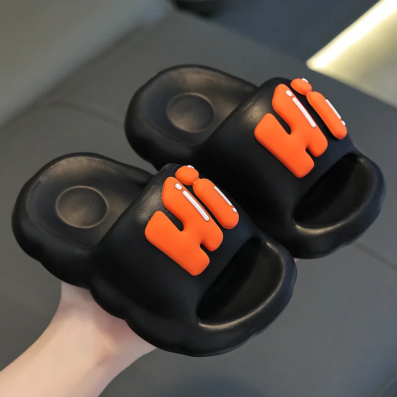 Black open-toe slide slippers with raised orange Hi lettering.