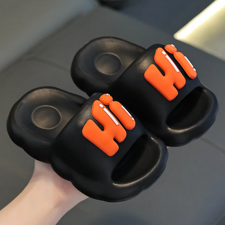 Black open-toe slide slippers with raised orange Hi lettering.