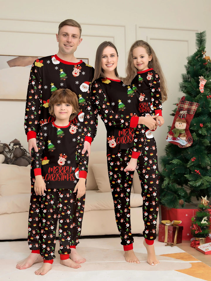 Two adults and two children wearing black Christmas pajamas with red trim beside a decorated tree