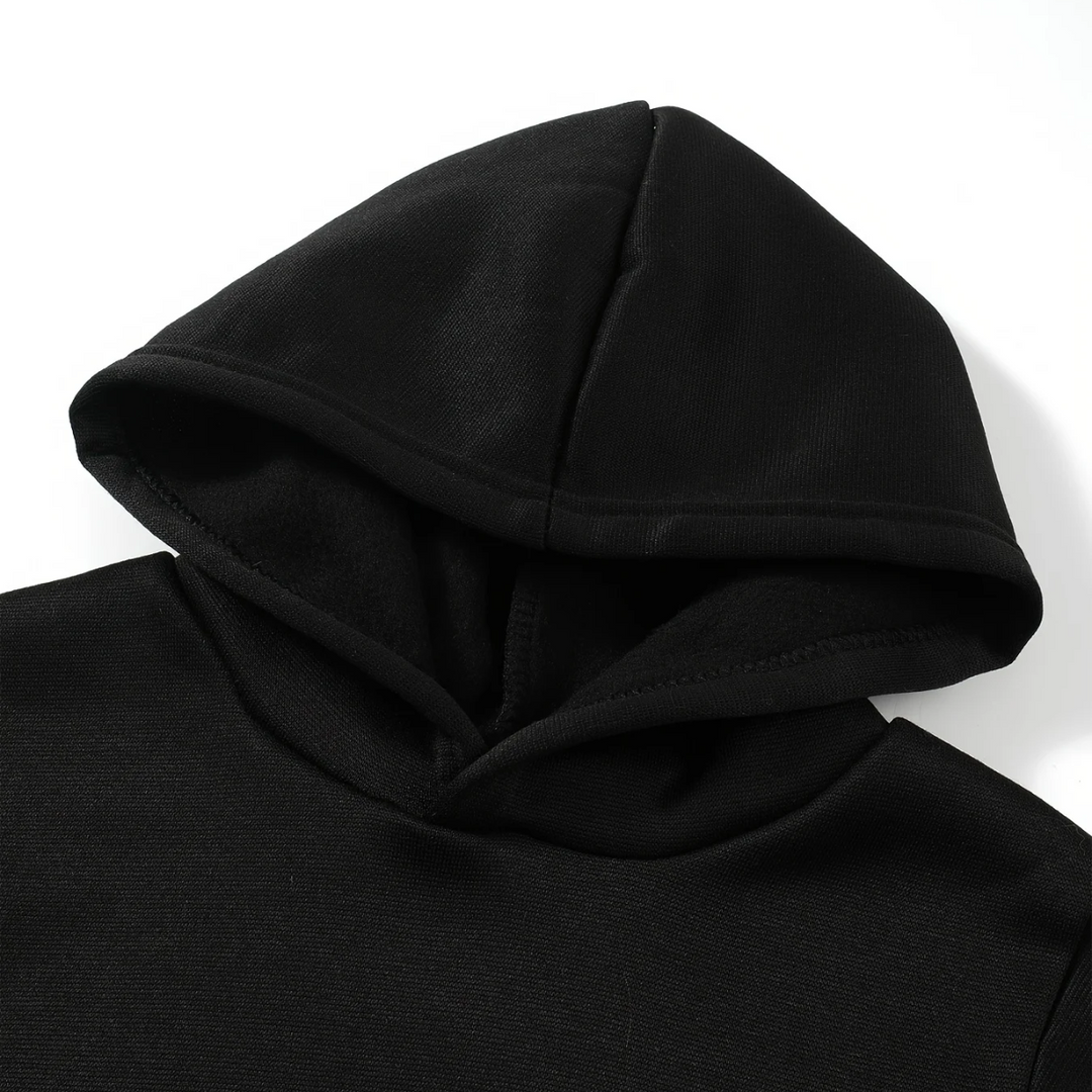 Close-up of the attached hood and neckline on the black hoodie.
