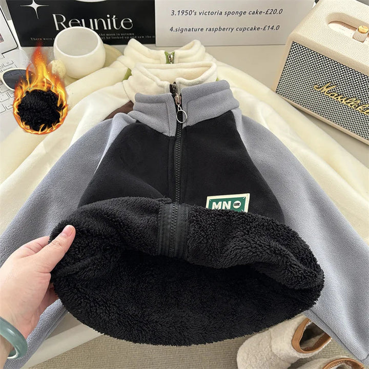 Black-and-gray jacket with the hem lifted to reveal black fleece lining