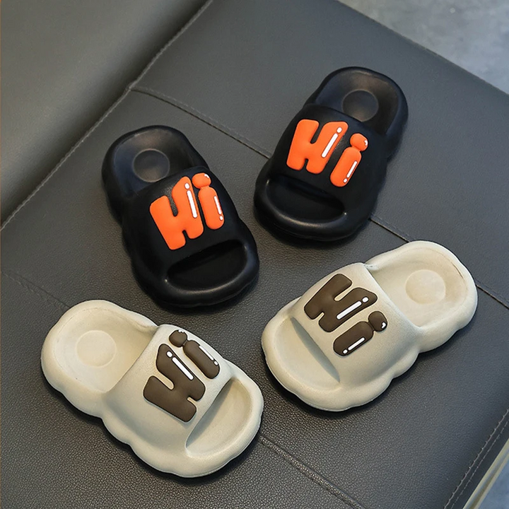 Black and khaki Hi slide slippers with orange and brown lettering.