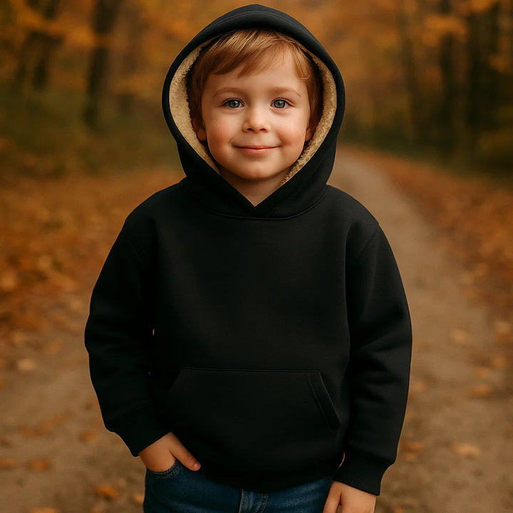 Child wearing a black hoodie with the fleece-lined hood up on an autumn path