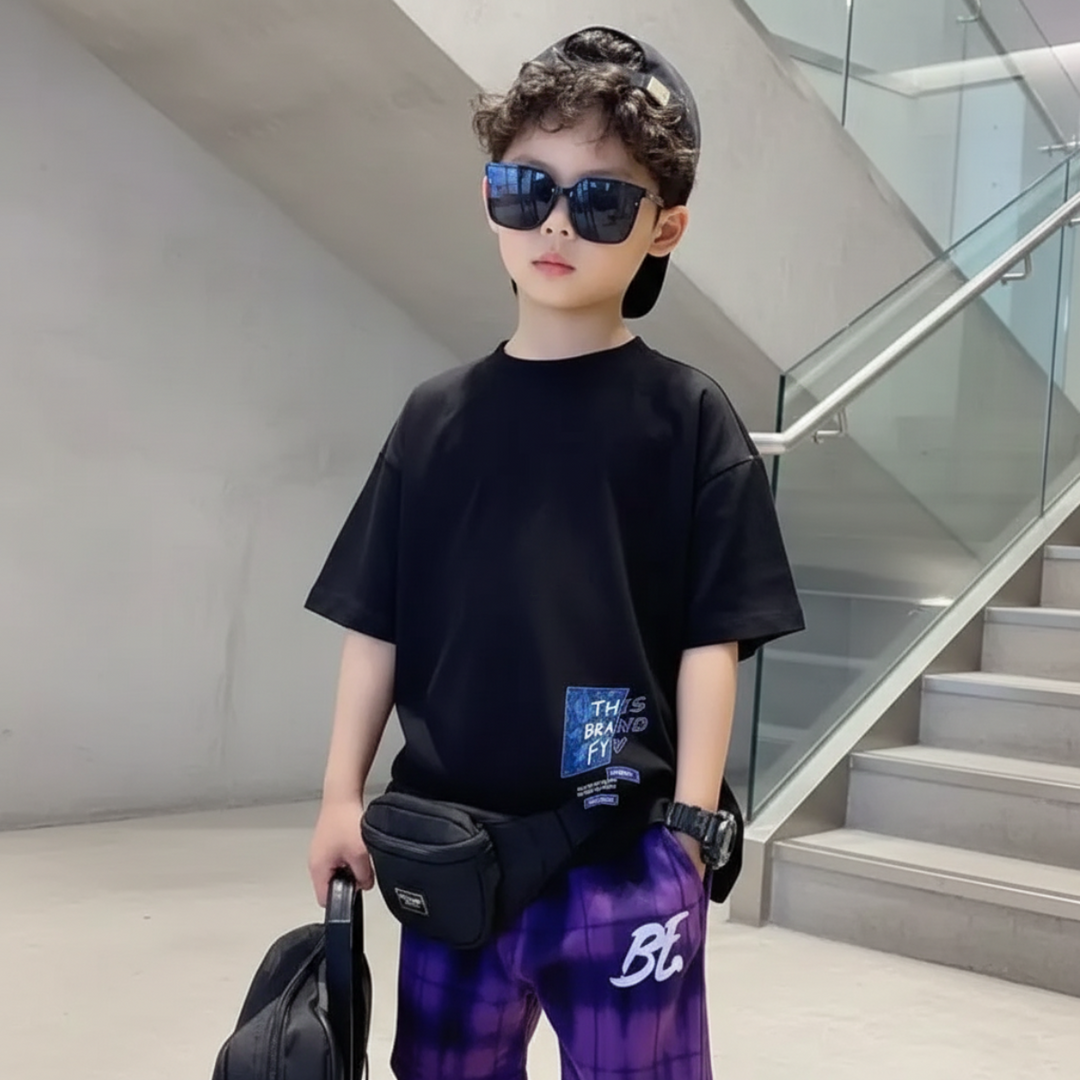 Boy wearing a black short-sleeve T-shirt with a small blue graphic near the hem.