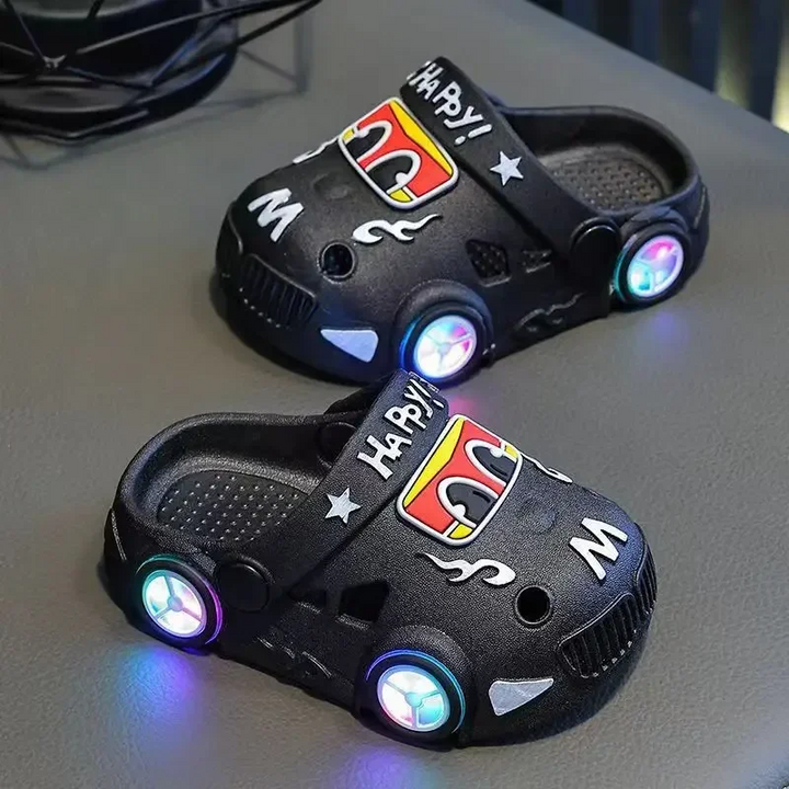 Black car slippers with colorful LED wheel lights and heel straps.