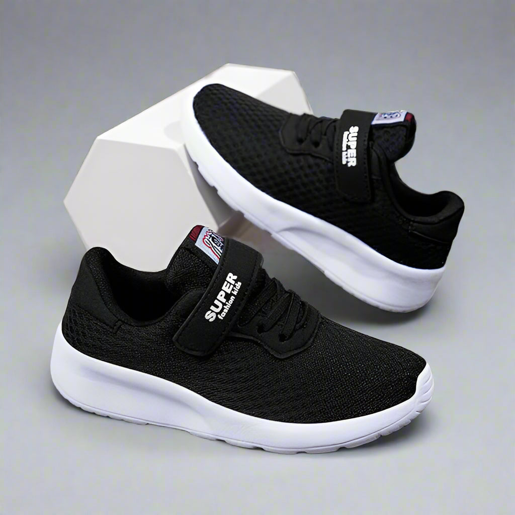 Pair of black kids' mesh sneakers with white soles and strap closures