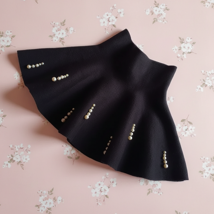 Black A-line knit skirt with short vertical rows of pearl-style beads