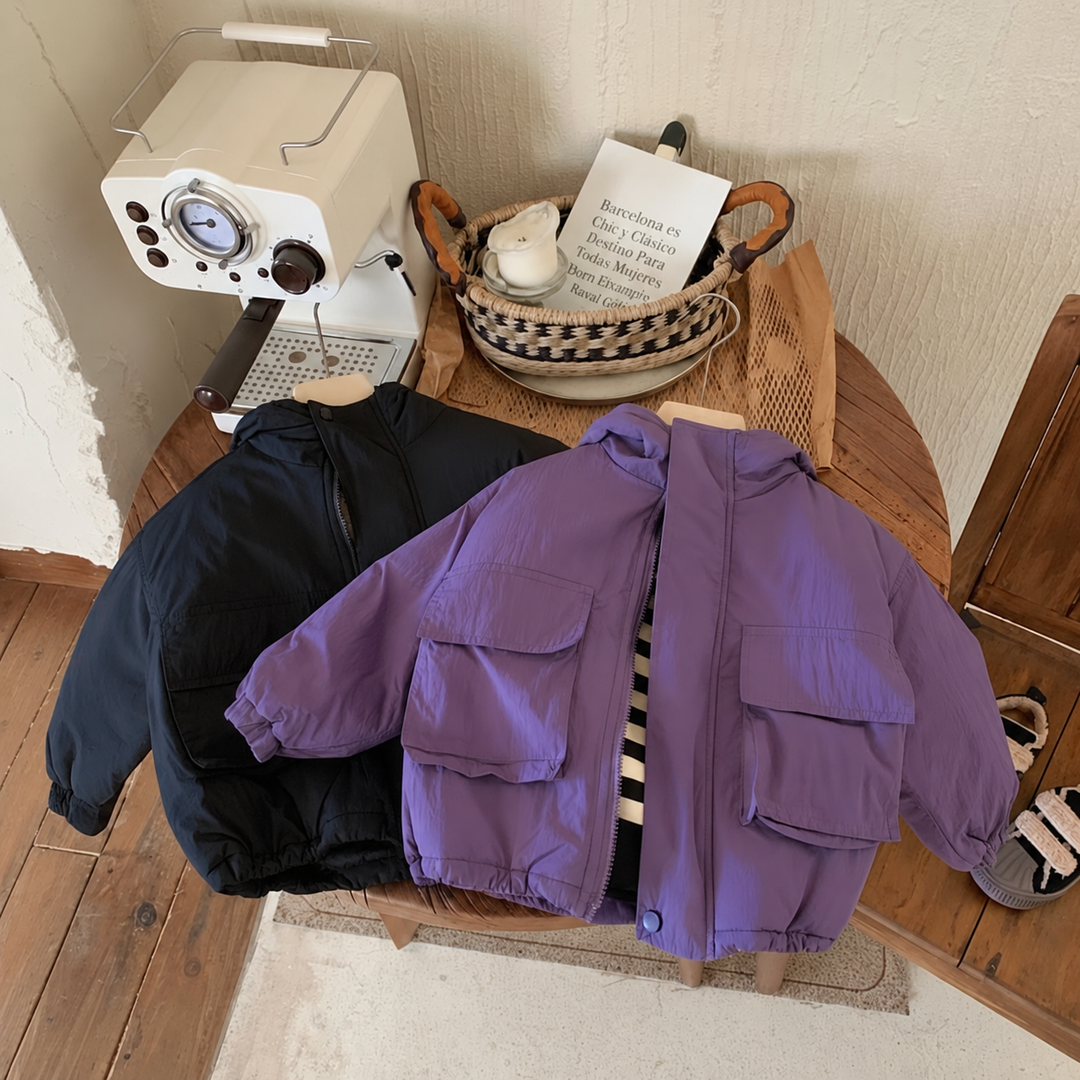 Black and purple windbreakers on a chair, with the purple jacket partly open