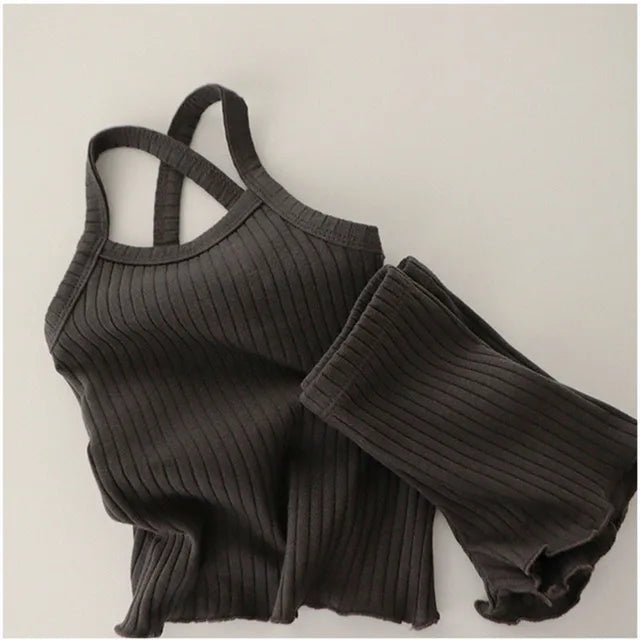 Black ribbed pajama set with a sleeveless tank, elastic-waist shorts, and wavy hems