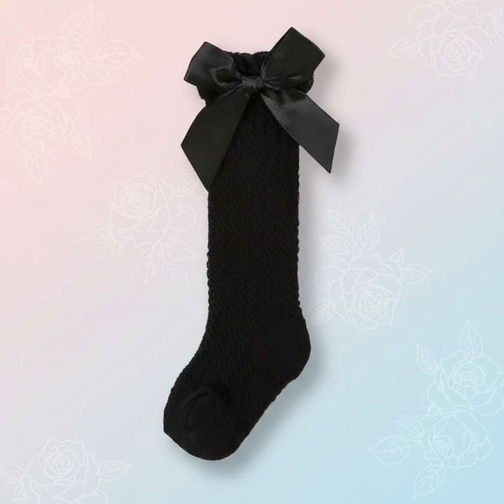 Black pointelle knee-high sock with a matching satin bow