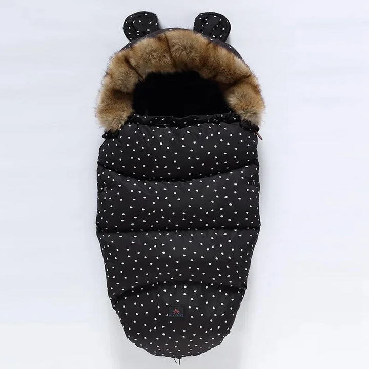 Black stroller footmuff with scattered white dots and a faux fur collar
