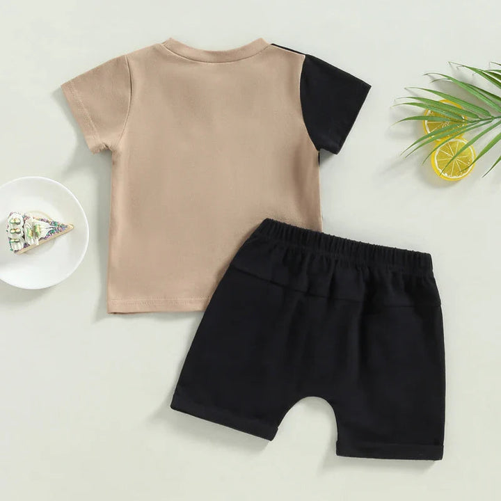 Rear view of the beige T-shirt with a black sleeve and matching black shorts