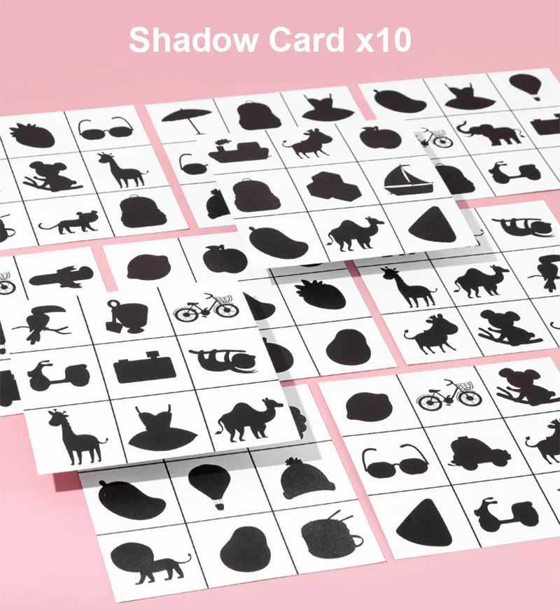 Shadow cards with black silhouettes of animals, vehicles, fruit, and everyday objects