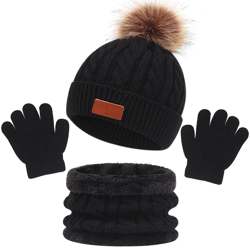 Black cable-knit winter set with a single-pom-pom hat, loop scarf, and gloves