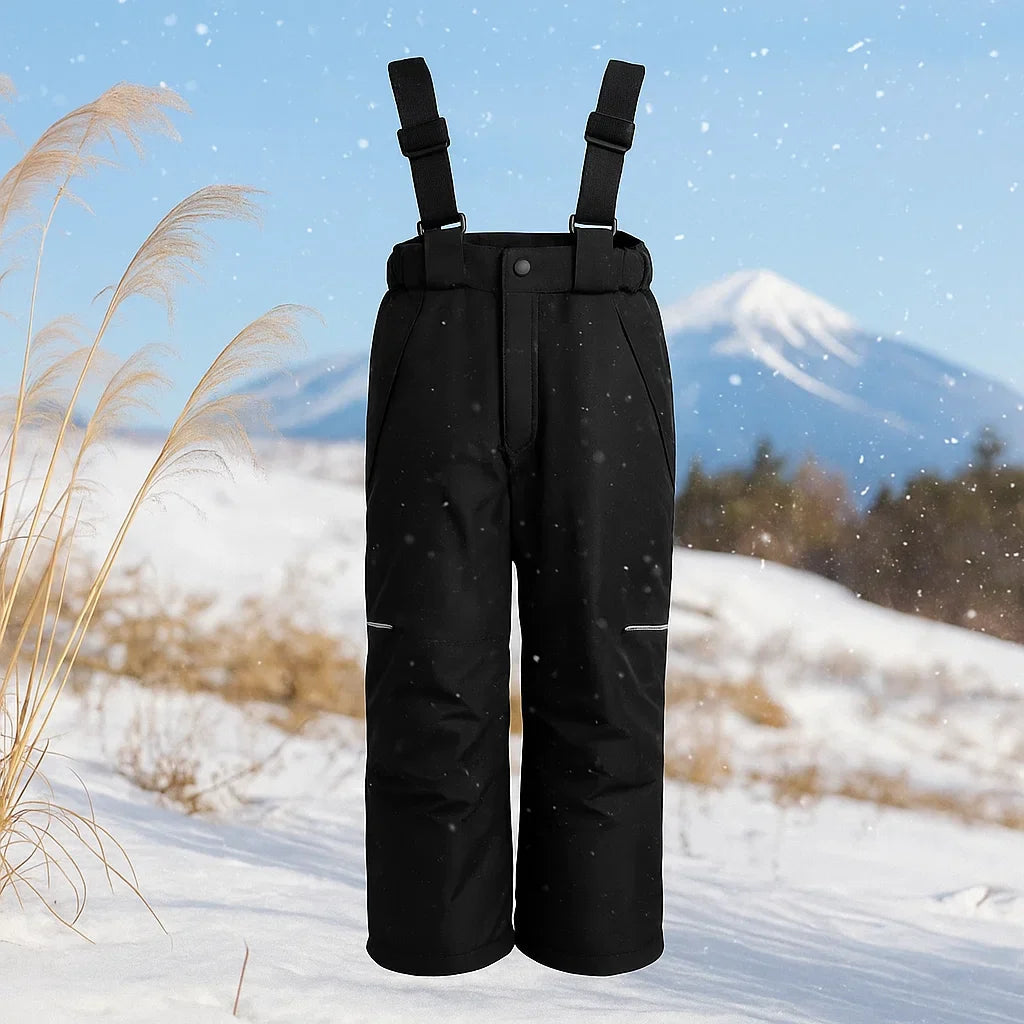 Black ski pants with adjustable suspenders displayed against a snowy mountain background.