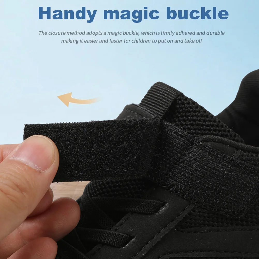 Hand opening the hook-and-loop strap on a black mesh sneaker