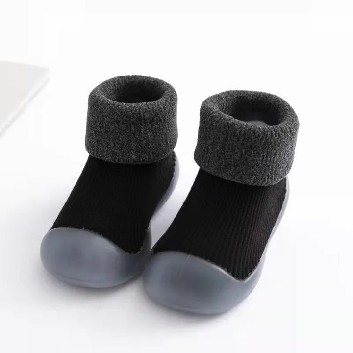 Black sock shoes with charcoal folded cuffs and gray rubber soles.