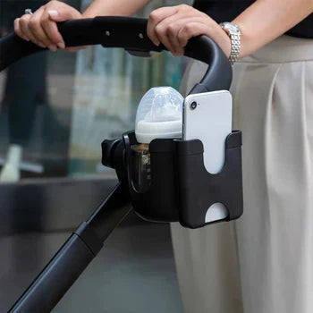 Black stroller holder with a bottle and white phone in separate compartments.