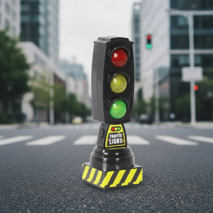 Black upright traffic-light toy with red, yellow, and green lenses and a striped base.