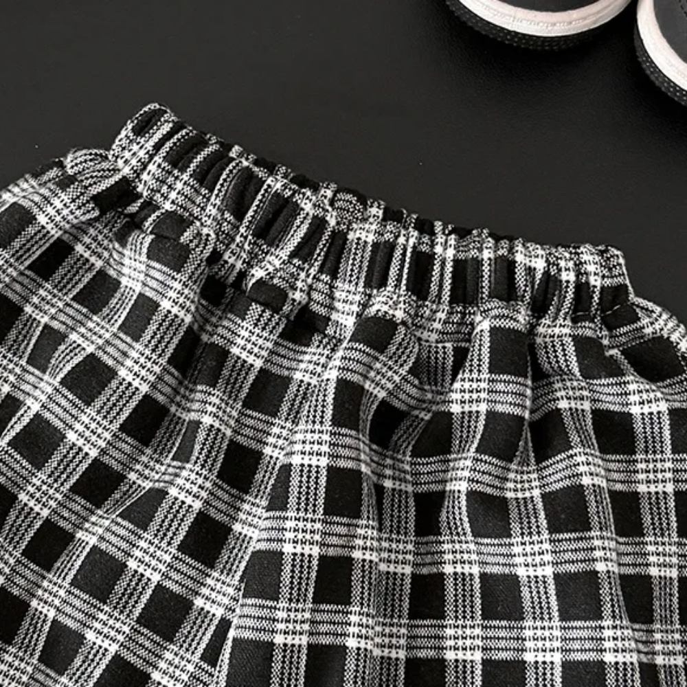 Close-up of the elastic waistband on black-and-white checkered pants