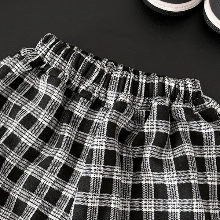 Close-up of the elastic waistband on black-and-white checkered pants