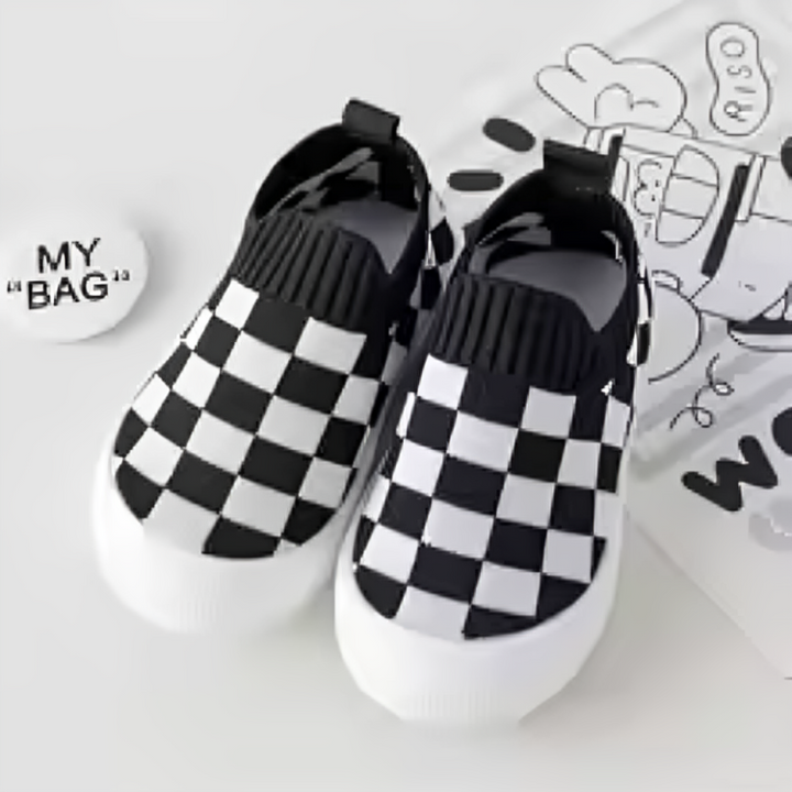 Pair of black-and-white checkered slip-on shoes with ribbed black openings