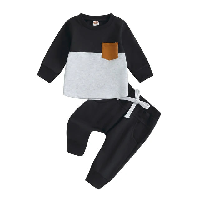 Black and white sweatshirt with a tan chest pocket paired with black joggers