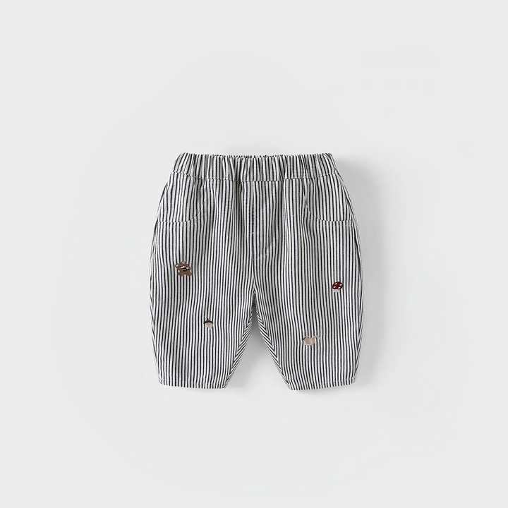 Black-and-white striped pants with an elastic waist and scattered embroidered details.