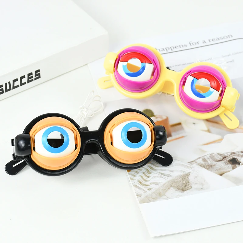 Black and yellow toy glasses with oversized blue eyes on a tabletop
