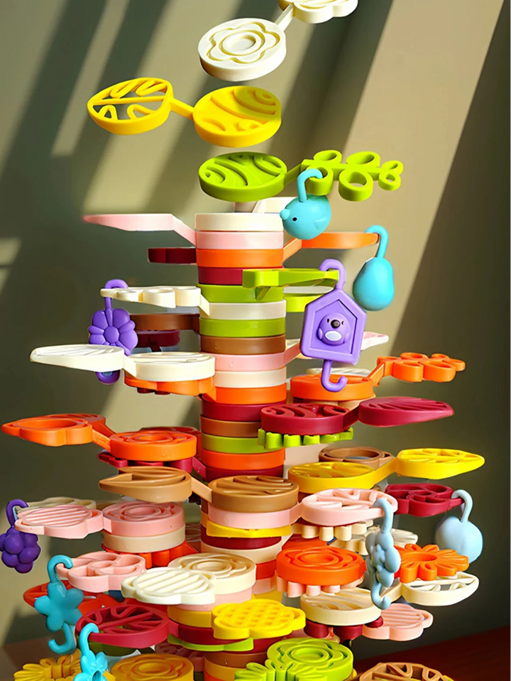 Colorful stacking tower with layered platforms, leaf shapes, and hanging decorative pieces