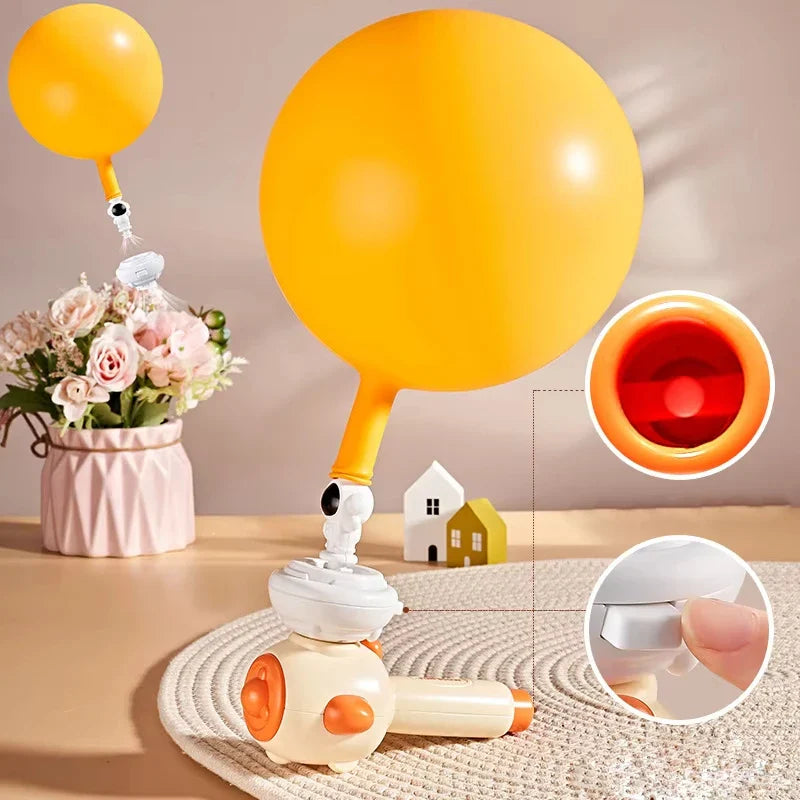 Yellow balloon attached above a blowing toy, with close-ups of the opening and connector.