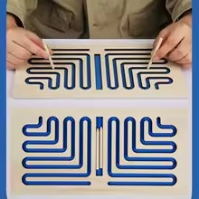 Blue wooden maze board with angular paths, shown in use and with styluses in its center slot