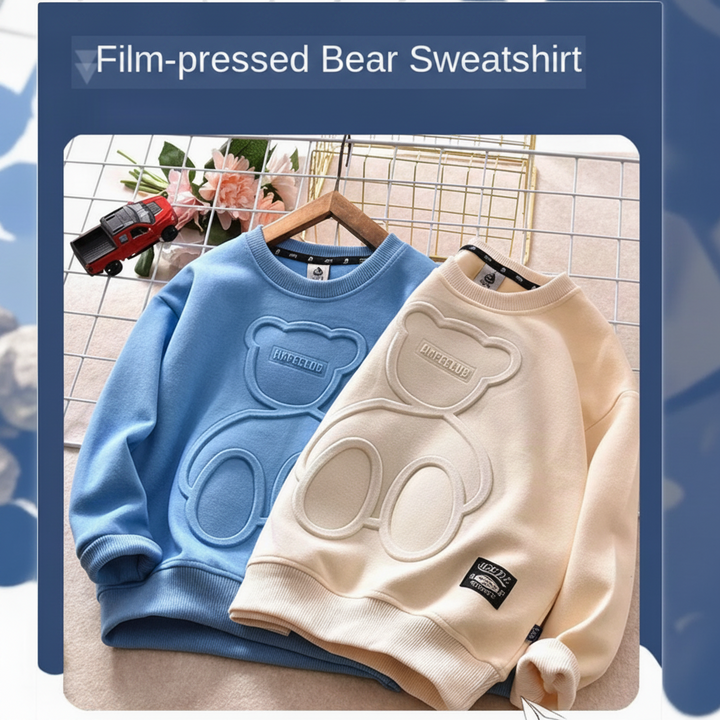 Blue and apricot pullover sweatshirts with raised bear outlines shown side by side