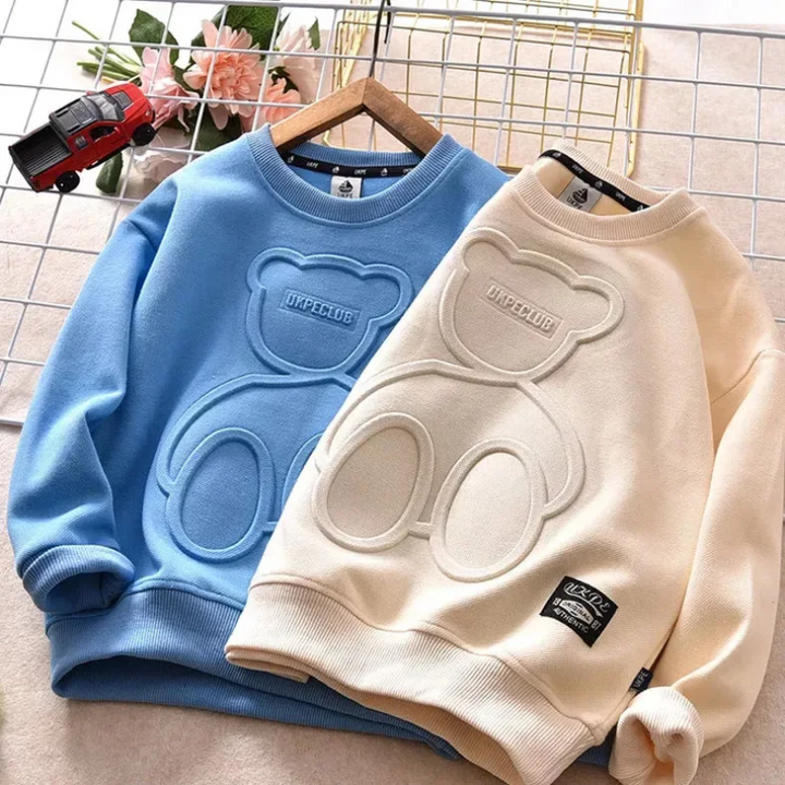 Blue and apricot long-sleeve sweatshirts with large raised bear designs