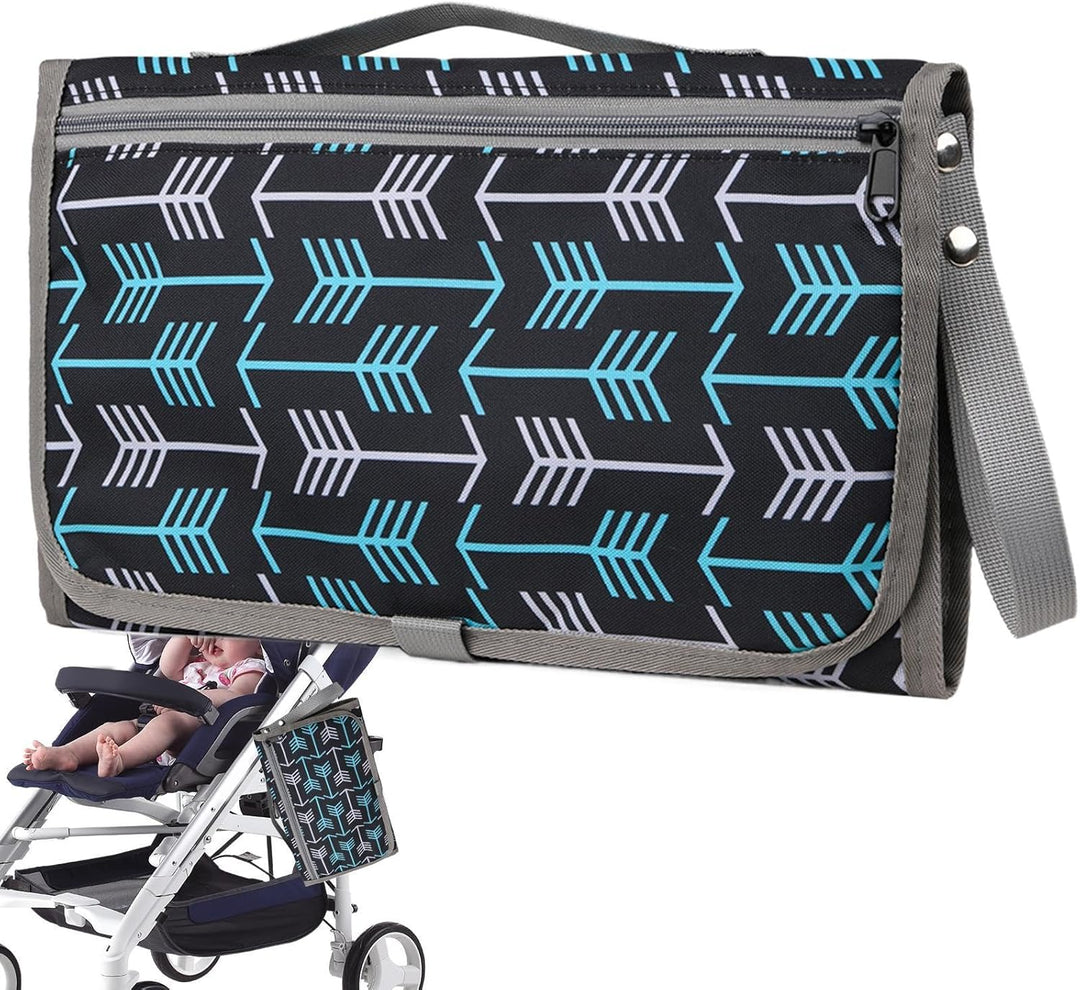 Black changing mat with blue and white arrows, gray trim, and a stroller attachment strap.