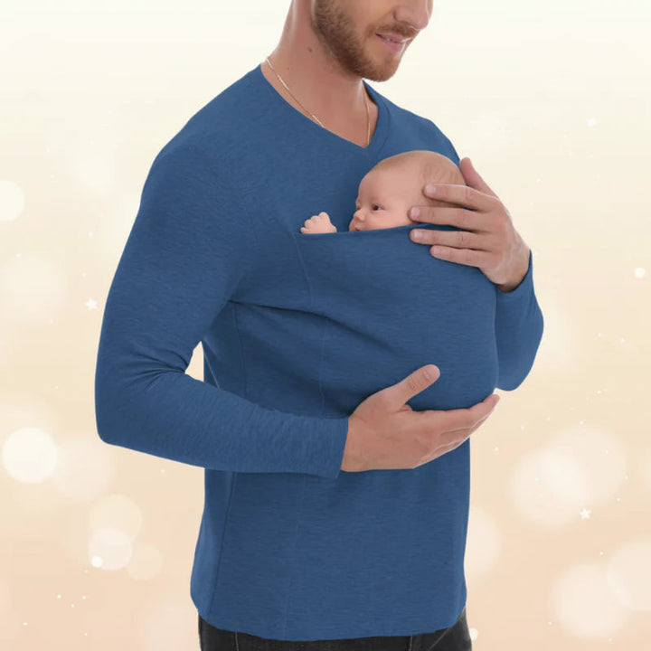Blue long-sleeve baby carrier shirt with a baby resting in the front pouch.