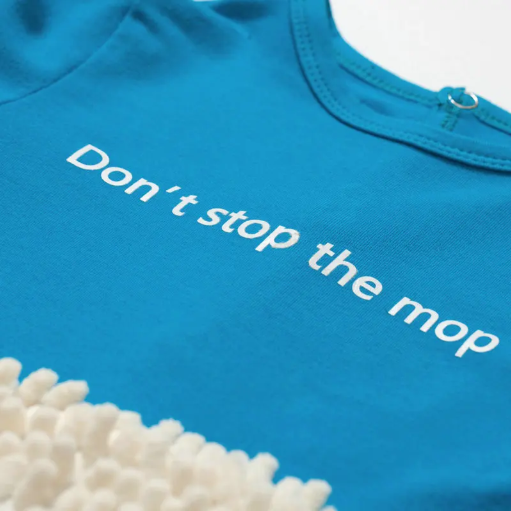 Printed chest slogan on a blue baby jumpsuit above white cleaning fibers