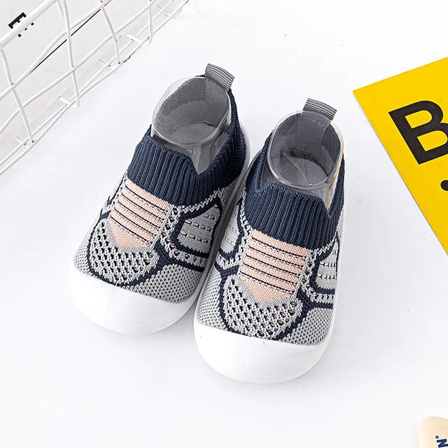 Blue baby slip-on shoes with navy cuffs, pale pink accents and white soles