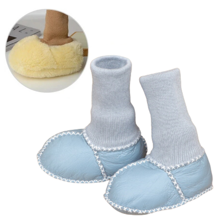 Blue baby slippers with pale blue knit cuffs and white stitched seams