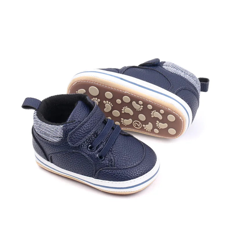 Blue baby sneakers showing the hook-and-loop strap and patterned brown sole
