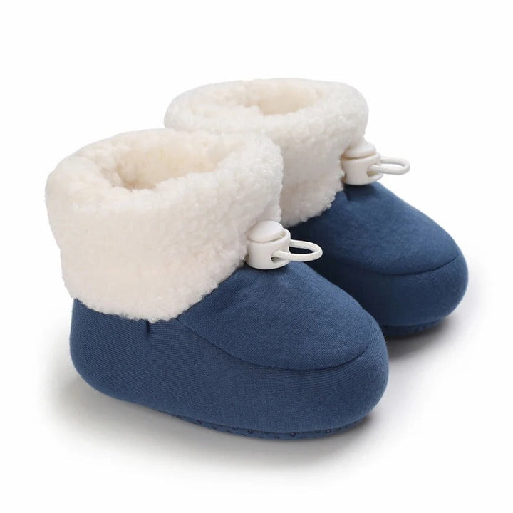 Blue baby winter boots with rounded toes, white toggles, and fluffy cuffs