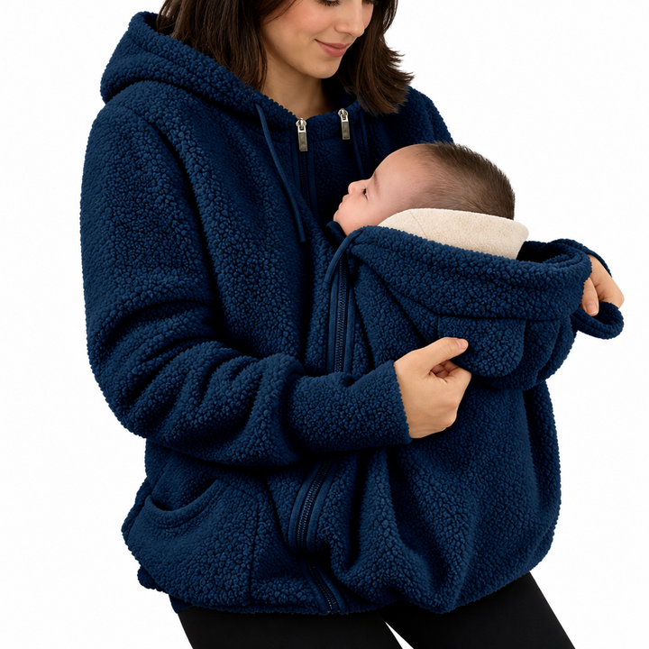 Blue babywearing jacket with a hood and roomy front section shown with a baby